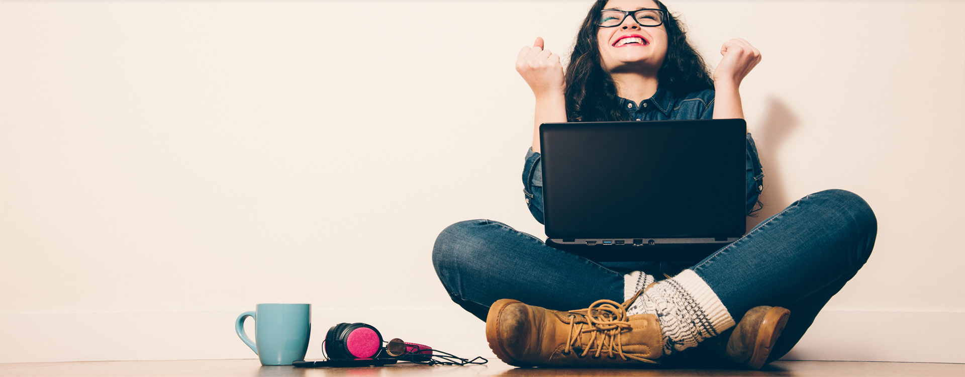 Female using a laptop and enjoying online financial planning.